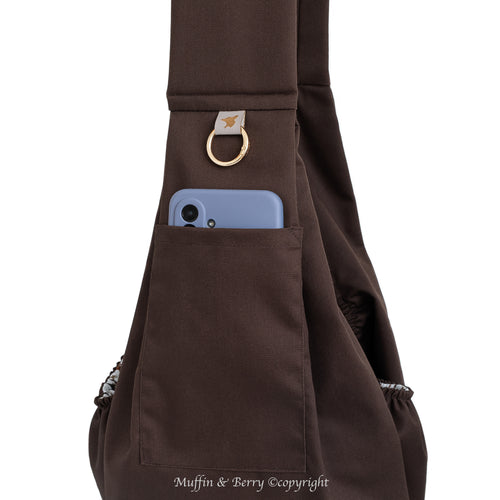 Close-up of BONNIE brown pet sling carrier front pocket with smartphone, gold O-ring and trench fabric texture detail, by Muffin & Berry