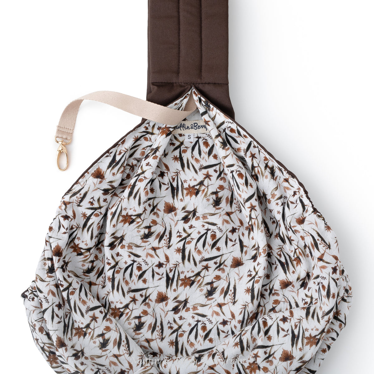 Interior of BONNIE pet sling carrier showing full botanical double gauze cotton lining in white, black and brown tones, Muffin & Berry label and gold safety clip, by Muffin & Berry
