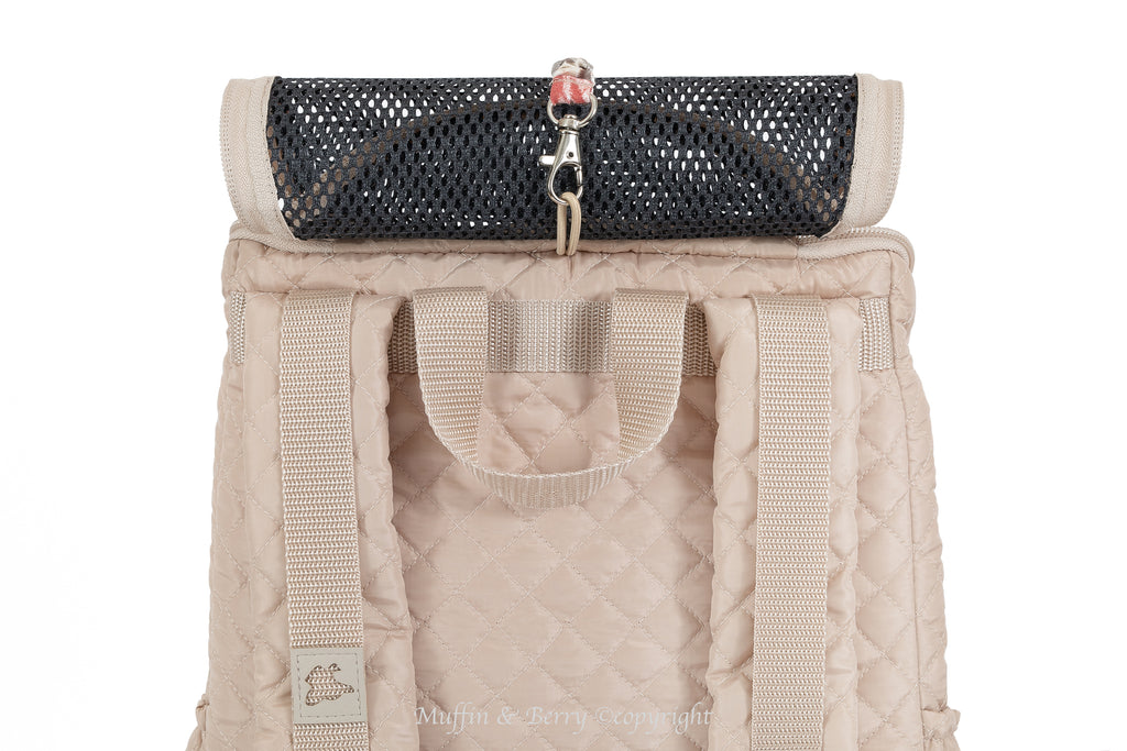 Beige quilted front pet carrier with top mesh window rolled up and snapped open, shoulder straps visible – by Muffin & Berry