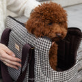 Chocolate brown and white houndstooth dog carrier bag KINSLEY in a lifestyle setting with brown toy poodle sitting inside, from Muffin & Berry