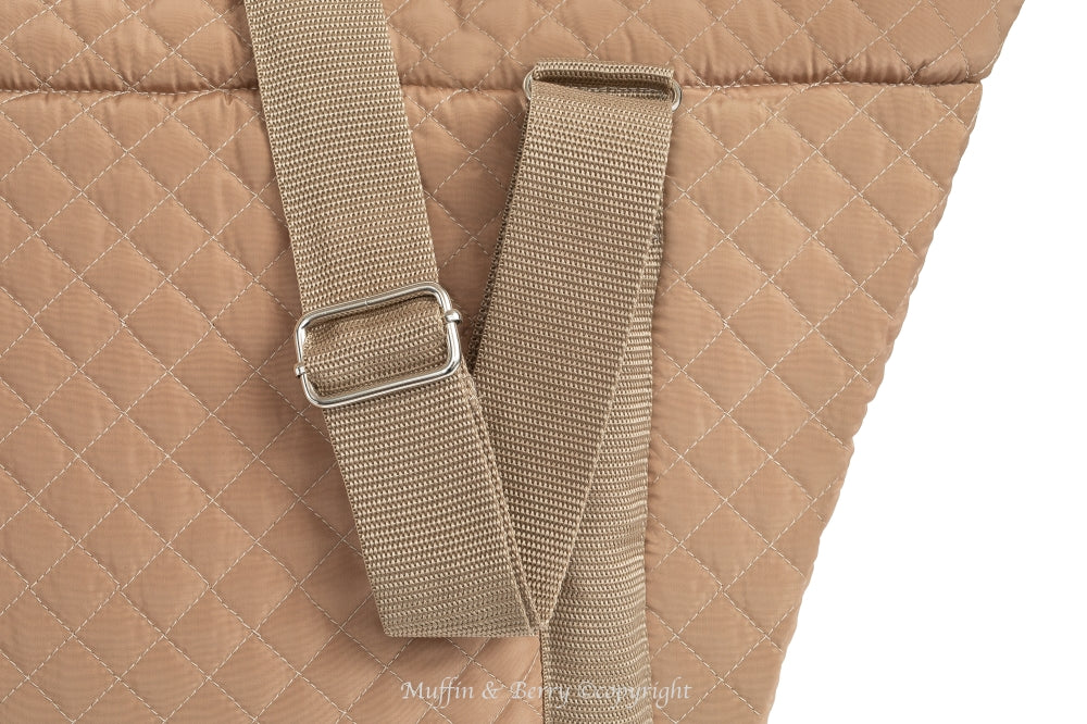 Close-up of adjustable camel nylon shoulder straps with silver hardware on AMELIA quilted dog carrier bag, by Muffin & Berry