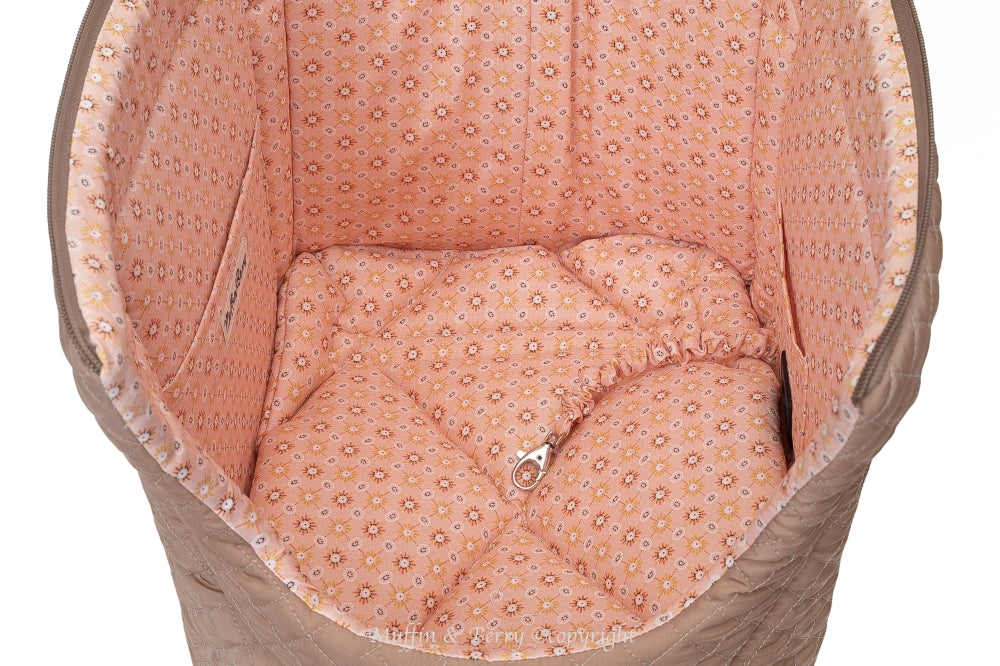 Top view of AMELIA dog carrier bag interior showing peach floral cotton lining, quilted cushion and silver safety leash clip, by Muffin & Berry